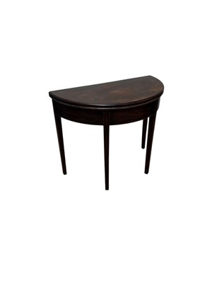 Lot 1244 - A Georgian inlaid mahogany demi-lune fold-over...