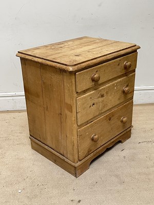 Lot 1050 - An old pine chest of three drawers, on bracket...