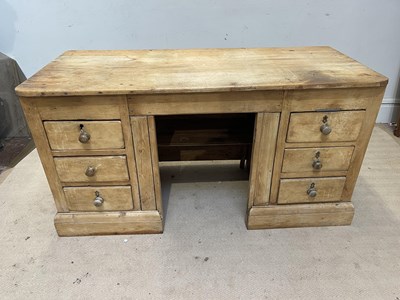 Lot 1051 - An old pine kneehole desk, with an arrangement...