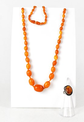Lot 1089 - An amber-style graduated bead necklace with...