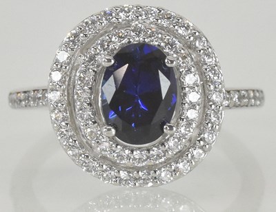 Lot 1144 - A 9ct white gold sapphire and white stone set...