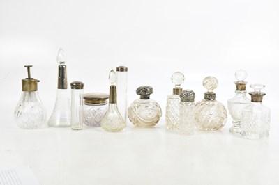 Lot 796 - A collection of thirteen cut glass dressing...