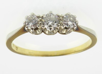 Lot 1005 - An 18ct gold three-stone diamond ring, the...