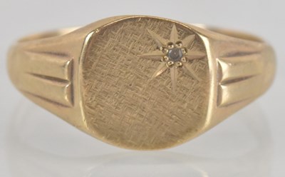 Lot 1175 - A 9ct gold signet ring, with star inset...