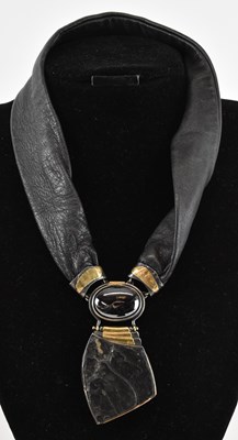 Lot 1229 - A contemporary lava stone and leather necklace,...