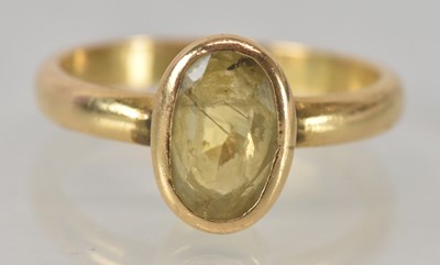 Lot 1130 - A yellow metal and topaz set single stone ring,...