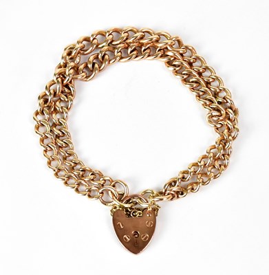 Lot 1057 - A 9ct yellow gold double curb link bracelet,...