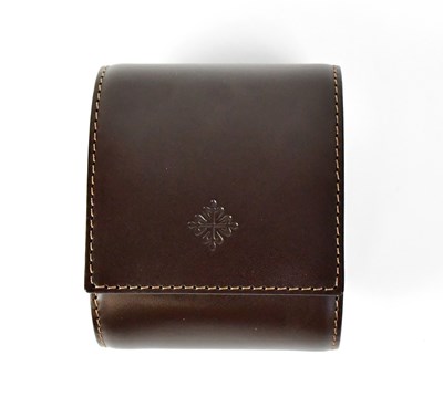 Lot 634 - PATEK PHILIPPE; a branded leather watch travel...