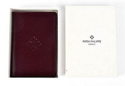 Lot 364 - PATEK PHILIPPE; a branded burgundy leather...