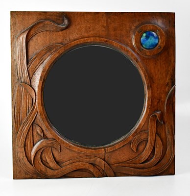 Lot 113 - An Arts and Crafts carved wood wall mirror...