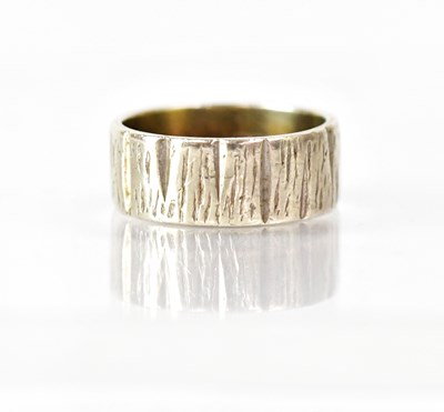 Lot 1035 - A 1970s 9ct white gold bark-effect ring, size...