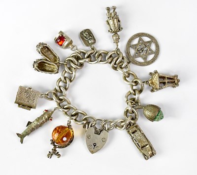 Lot 1061 - A hallmarked silver charm bracelet with a...