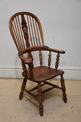 Lot 1179 - An elm seated splat back Windsor elbow chair...