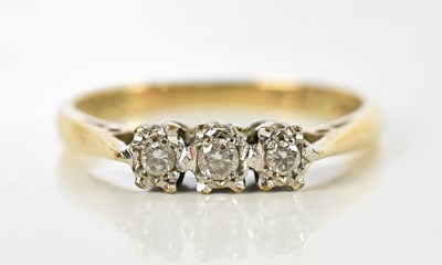 Lot 135 - A 9ct yellow gold illusion set three stone...