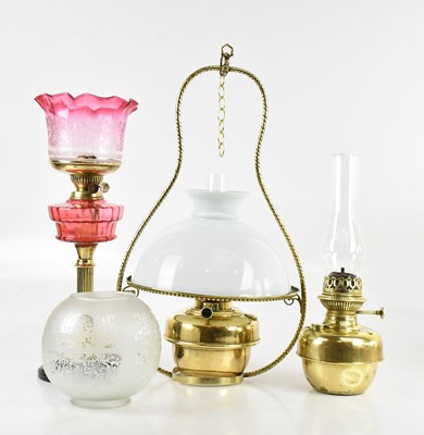Lot 1573 - A late Victorian oil lamp, with cranberry and...