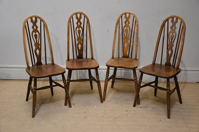 Lot 1105 - A set of four Ercol type elm seated chairs...