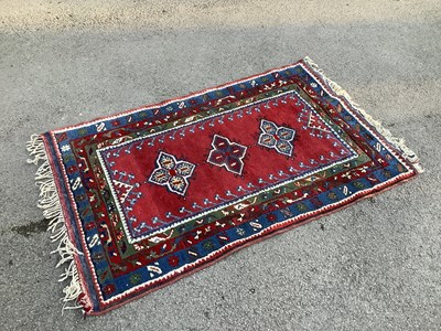 Lot 1324 - A hand knotted Turkish red ground rug, 150 x...