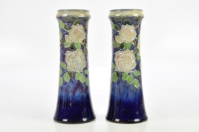 Lot 1641 - DOULTON LAMBETH; a pair of blue ground vases,...