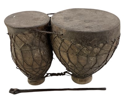 Lot 609 - An African terracotta and calfskin bongo,...