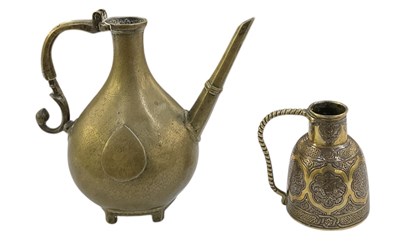 Lot 659 - An Islamic brass ewer (lacking lid), height...