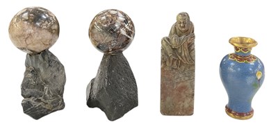 Lot 646 - A pair of Oriental carved hardstone orbs, on...