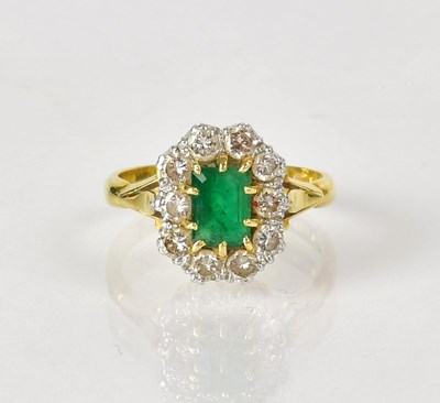 Lot 749 - An 18ct yellow gold ring set with an emerald...