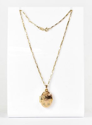 Lot 1080 - A 9ct yellow gold oval locket with floral...
