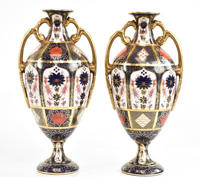 Lot 1583 - ROYAL CROWN DERBY; a pair of twin handled...