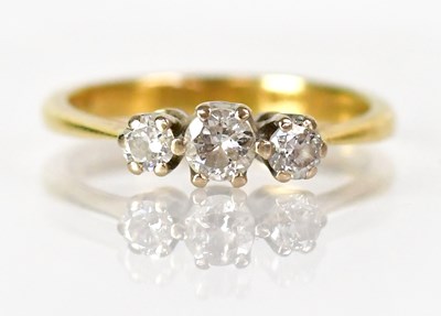 Lot 1027 - An 18ct yellow gold ring set with three...