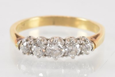 Lot 1133 - An 18ct yellow gold five stone diamond ring,...