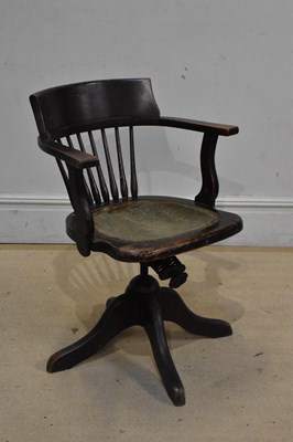 Lot 1243 - An early 20th century stained wooden revolving...