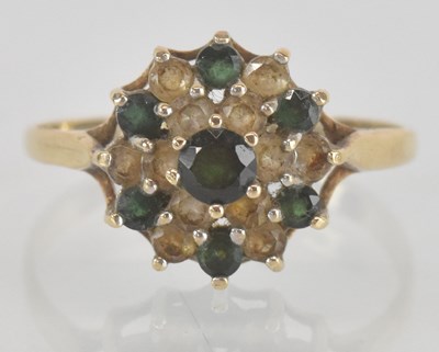 Lot 1182 - A 9ct gold dress ring set with green and white...