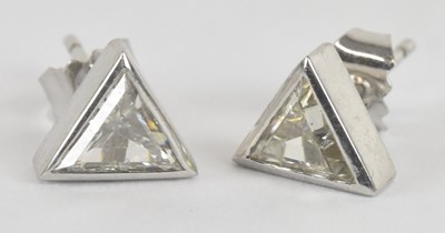 Lot 1234 - A pair of white metal triangular diamond set...