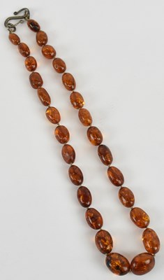 Lot 1211 - A single strand amber bead necklace, with 925...
