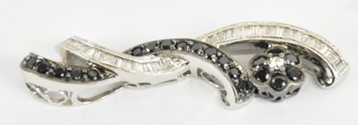 Lot 1267 - A 14ct white gold black and white diamond set...