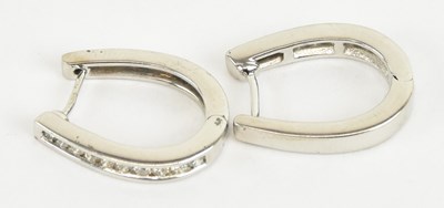 Lot 1243 - A pair of 9ct white gold diamond set hoop...