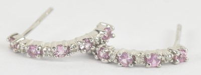 Lot 1253 - A pair of 9ct white gold diamond and ruby set...