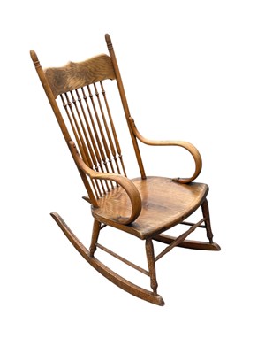Lot 2187 - An early 20th century oak spindle back rocking...