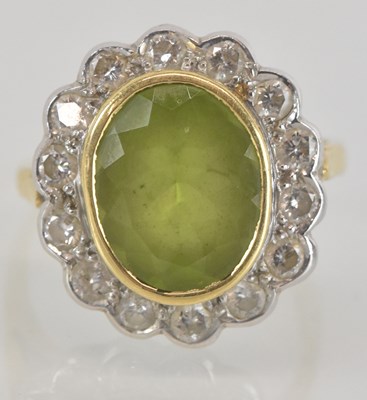 Lot 1108 - An 18ct gold peridot and diamond set ring, the...