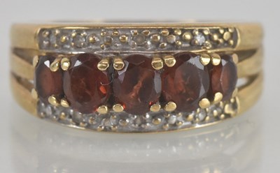 Lot 1179 - A 9ct gold garnet and diamond set ring, the...