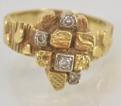 Lot 1117 - A contemporary gold and diamond ring, the...