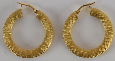 Lot 1247 - A pair of 9ct gold contemporary textured hoop...