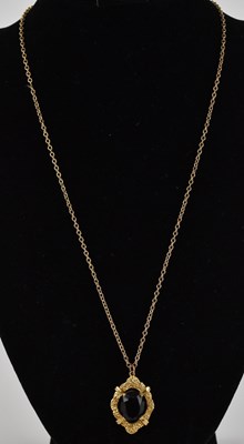 Lot 1212 - A 9ct gold bark textured necklace pendant,...