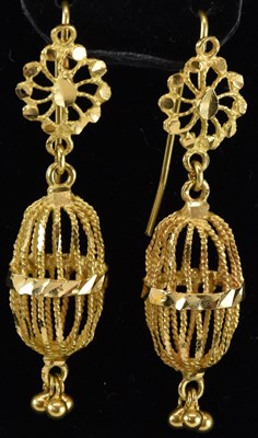 Lot 1245 - A pair of unmarked bright gold earrings, with...
