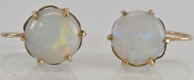 Lot 1251 - A pair of round opal stud earrings, each claw...
