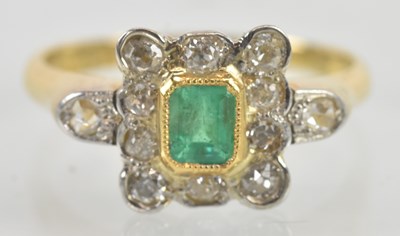 Lot 1116 - An 18ct yellow gold and platinum emerald and...