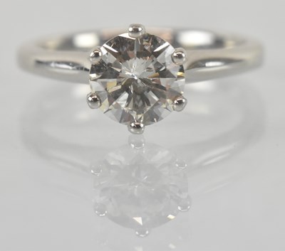 Lot 1102 - A platinum diamond solitaire ring, the central...