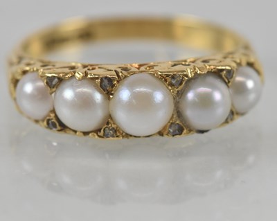 Lot 1159 - An 18ct yellow gold seed pearl set five stone...