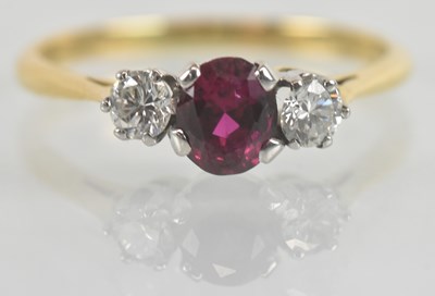 Lot 1135 - An 18ct gold ruby and diamond three stone ring,...