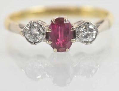 Lot 1138 - An 18ct yellow gold ruby and diamond set three...